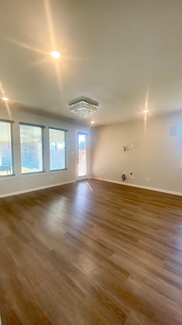 unfurnished room featuring dark hardwood / wood-style flooring