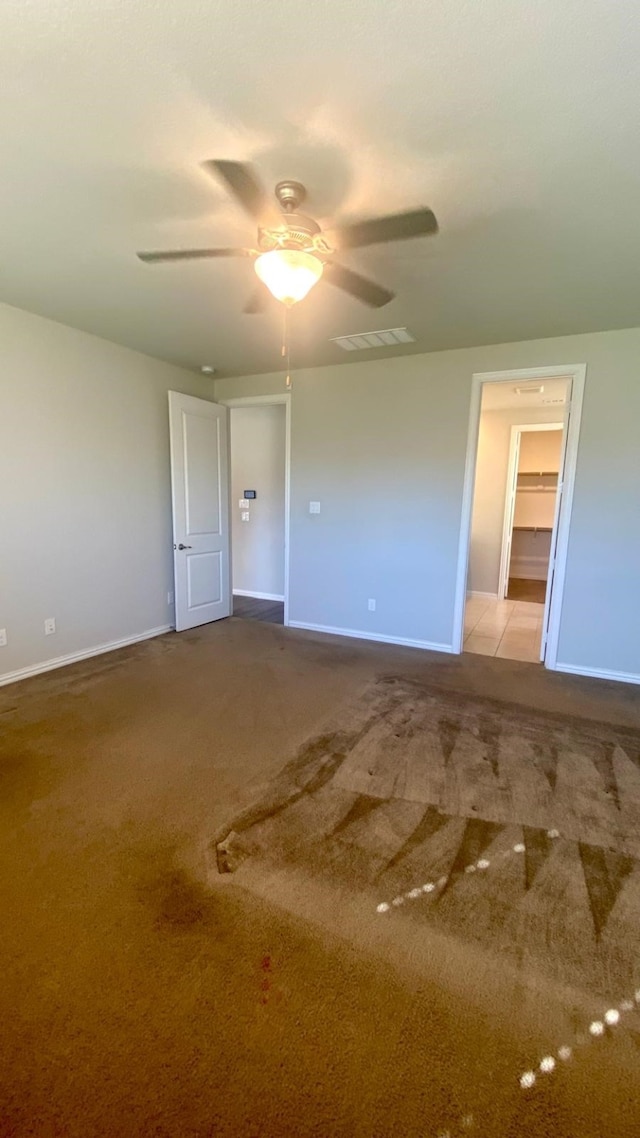 spare room with light carpet and ceiling fan