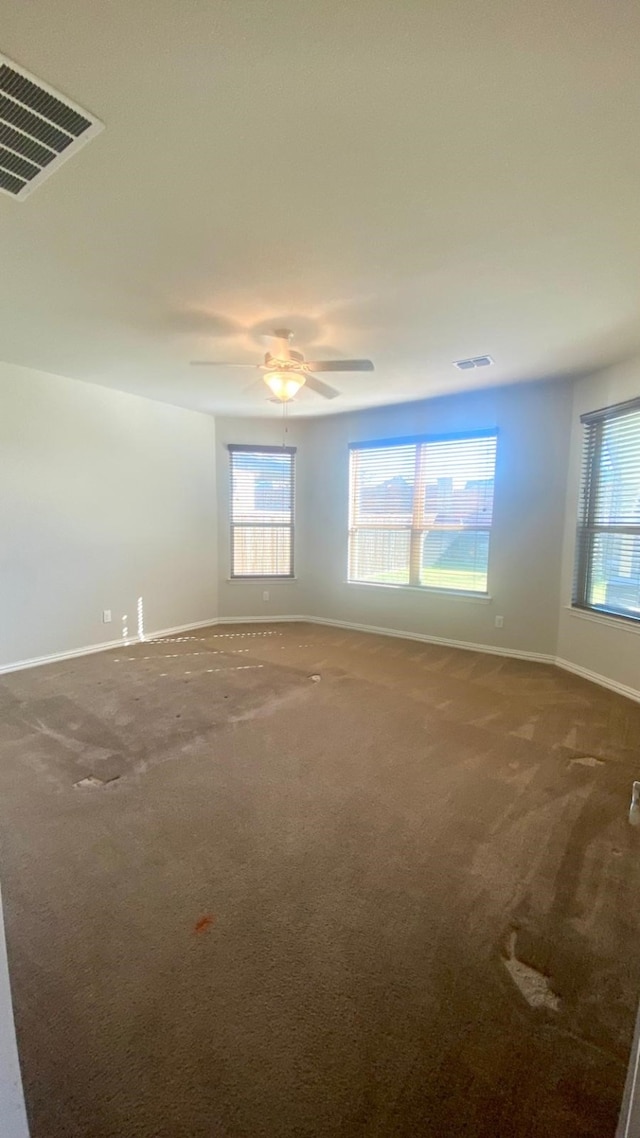 empty room featuring carpet flooring and ceiling fan