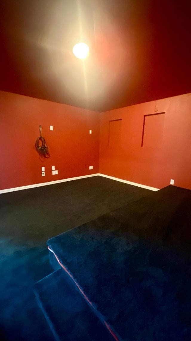 bonus room featuring carpet and vaulted ceiling