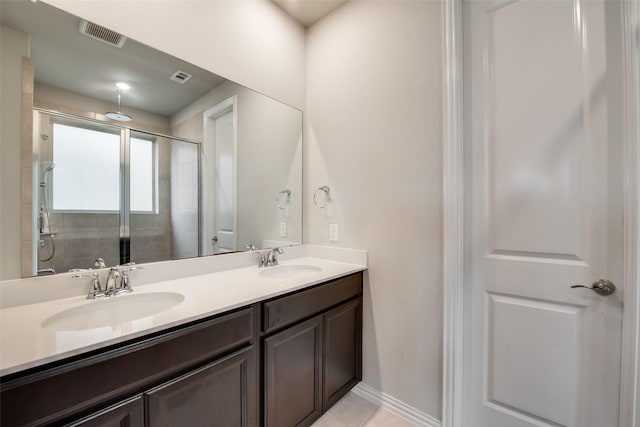 bathroom with vanity, tile patterned floors, and a shower with door