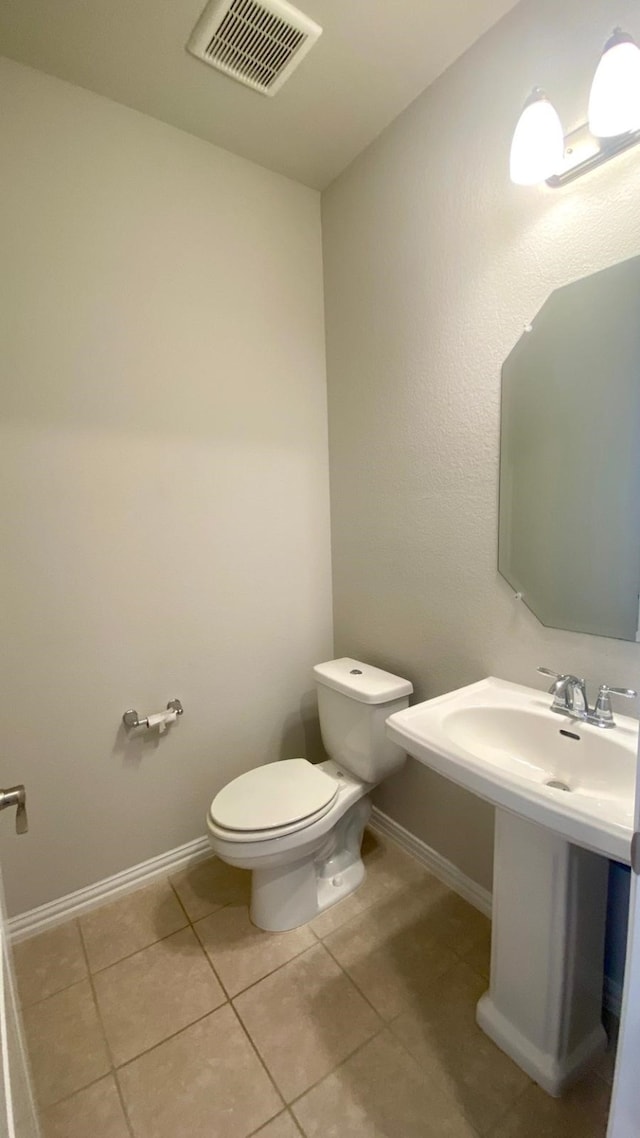 bathroom featuring tile patterned flooring and toilet