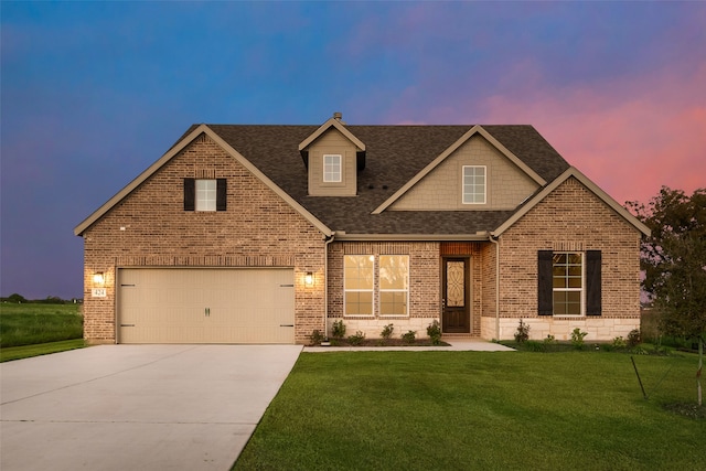 view of front facade featuring a yard and a garage