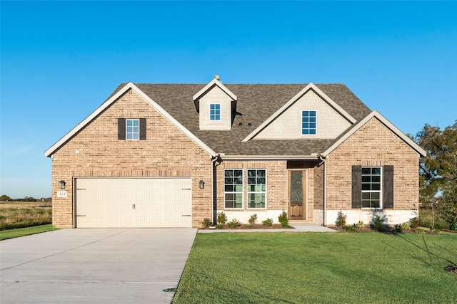 view of front of house with a garage and a front lawn