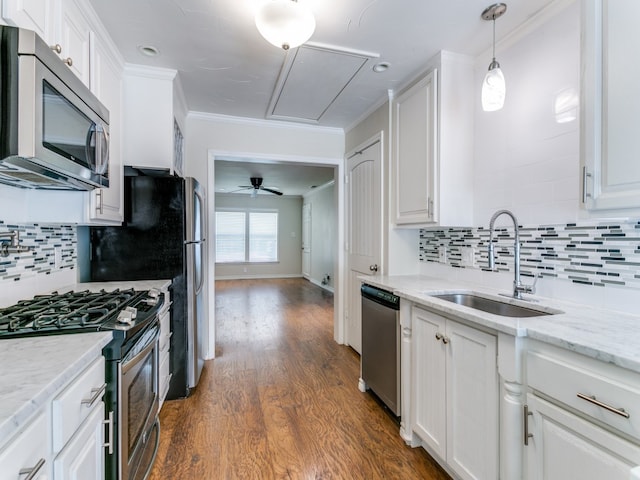 kitchen featuring white cabinets, sink, tasteful backsplash, stainless steel appliances, and dark hardwood / wood-style floors