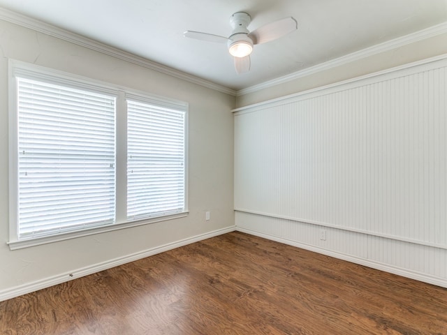 empty room featuring ceiling fan, crown molding, and dark hardwood / wood-style flooring