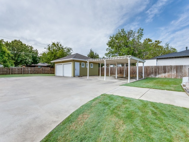 view of yard featuring a garage and a pergola