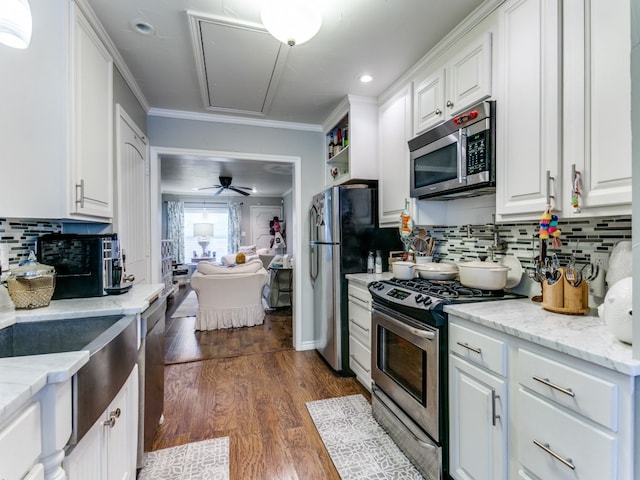 kitchen featuring decorative backsplash, dark hardwood / wood-style floors, stainless steel appliances, and white cabinets