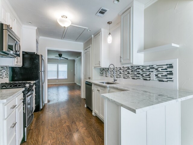 kitchen featuring light stone counters, white cabinets, sink, dark wood-type flooring, and appliances with stainless steel finishes