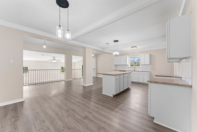 unfurnished bedroom featuring light carpet, ceiling fan, a walk in closet, and a closet