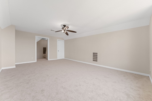 carpeted empty room with ceiling fan and lofted ceiling