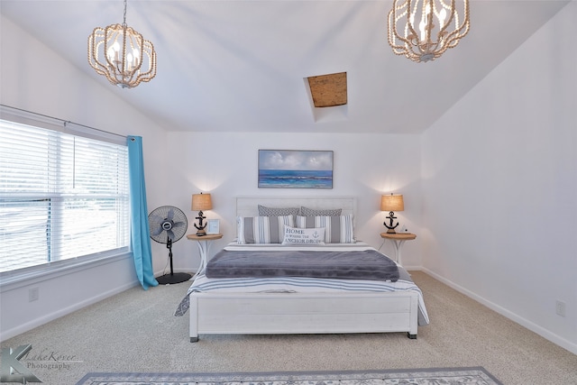 bedroom featuring a notable chandelier, vaulted ceiling, and carpet