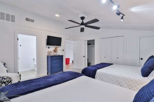 bedroom with lofted ceiling, ceiling fan, and ensuite bathroom