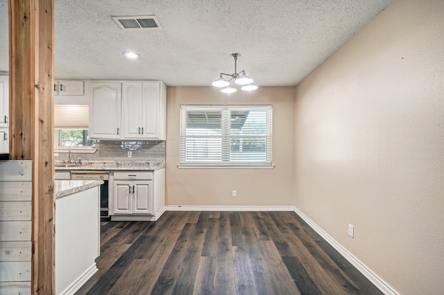 kitchen featuring dark wood finished floors, visible vents, white cabinets, and dishwasher