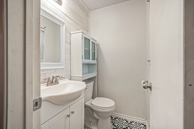 bathroom with vanity, a textured ceiling, and toilet