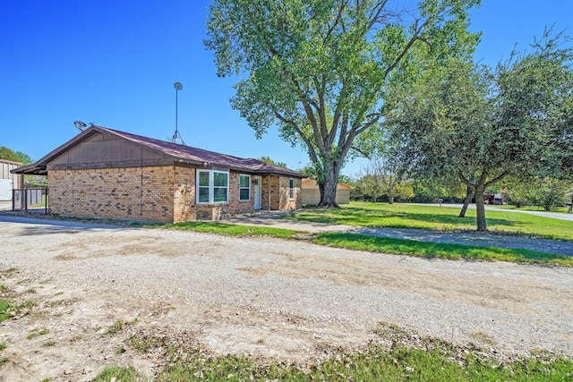 view of front facade with a front lawn and brick siding