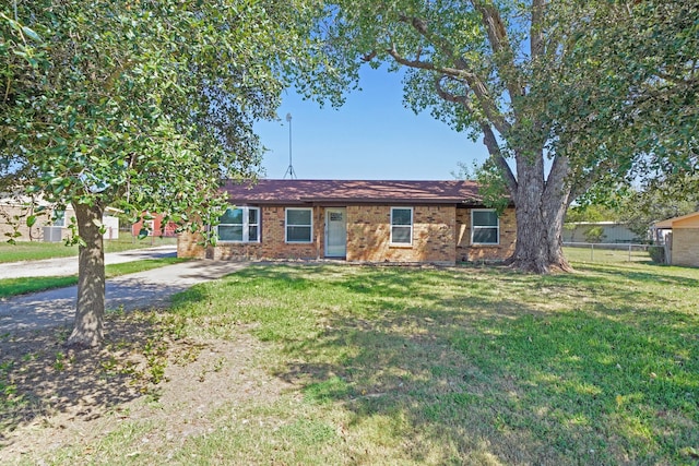 single story home featuring brick siding, a front yard, and fence