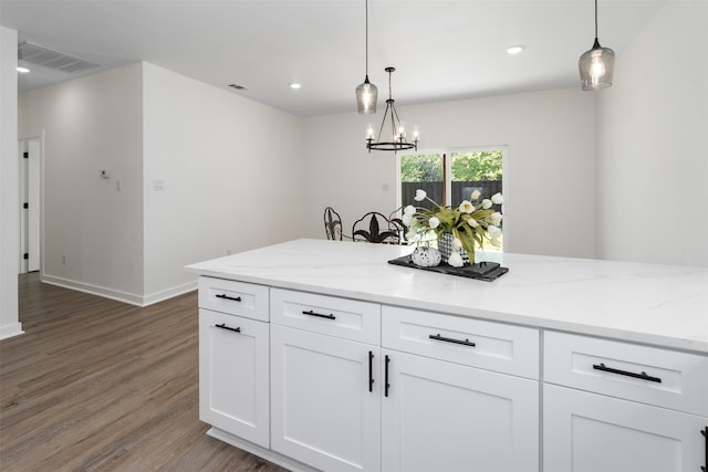 kitchen featuring a chandelier, hardwood / wood-style floors, white cabinets, and hanging light fixtures