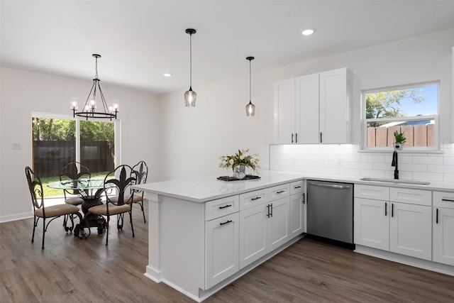 kitchen featuring dishwasher, sink, dark wood-type flooring, decorative light fixtures, and white cabinets