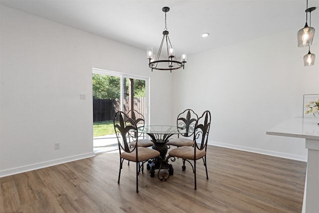 dining area featuring a chandelier and wood-type flooring