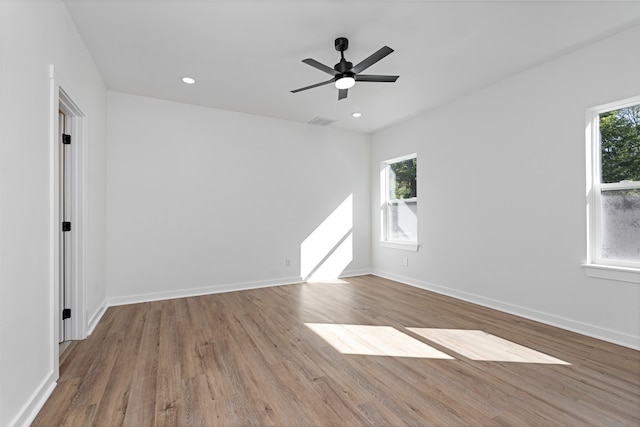 unfurnished room with ceiling fan, plenty of natural light, and light hardwood / wood-style floors