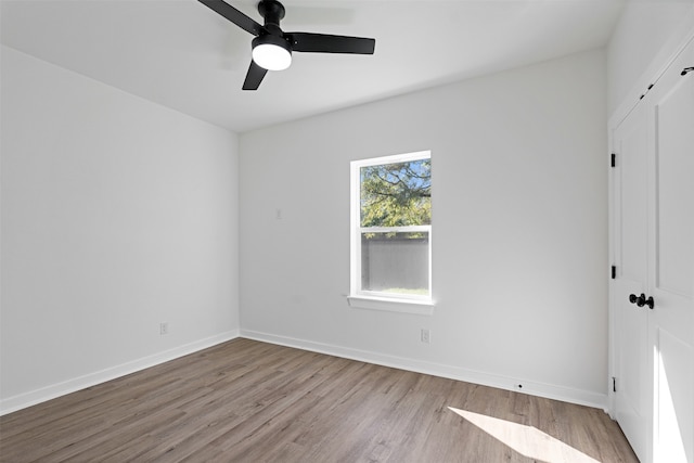 unfurnished bedroom featuring ceiling fan, a closet, and light hardwood / wood-style flooring