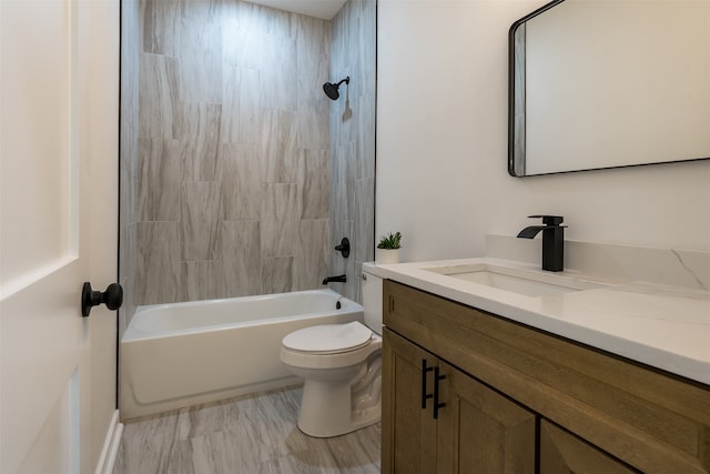 full bathroom featuring vanity, tiled shower / bath combo, and toilet