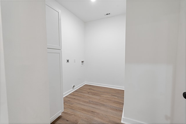 clothes washing area with hookup for a washing machine, light hardwood / wood-style flooring, and electric dryer hookup