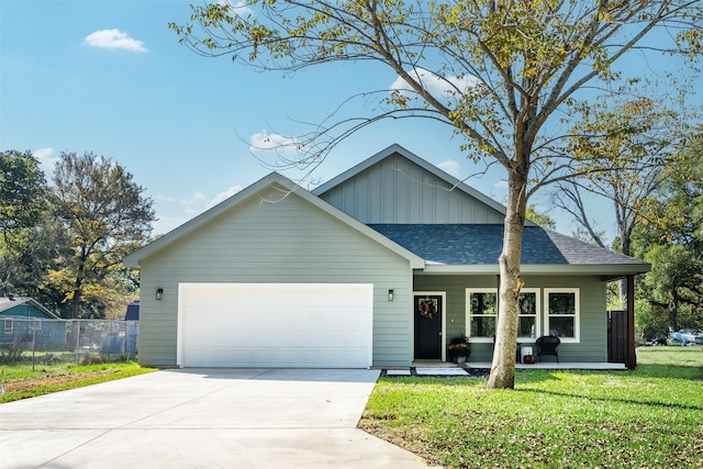 view of front of home with a garage and a front lawn