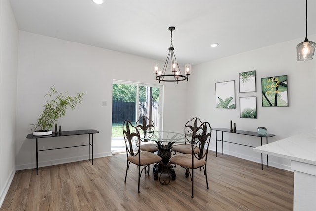 dining area featuring hardwood / wood-style floors and a chandelier