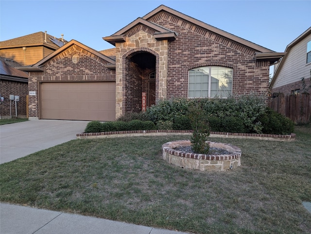 view of front of home with a front yard and a garage