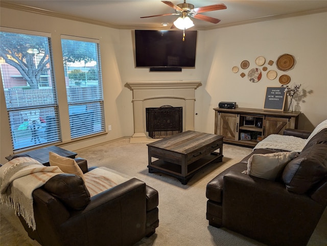 living room with ceiling fan, carpet floors, and crown molding