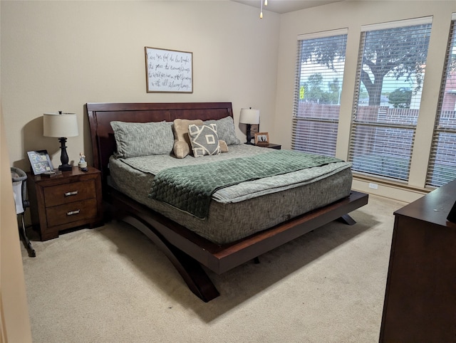 bedroom featuring light carpet