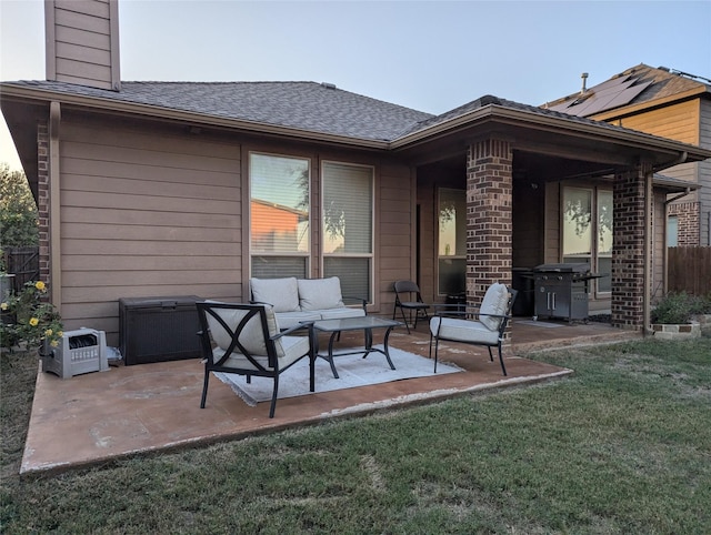 back of house featuring outdoor lounge area, a patio, a chimney, and a lawn