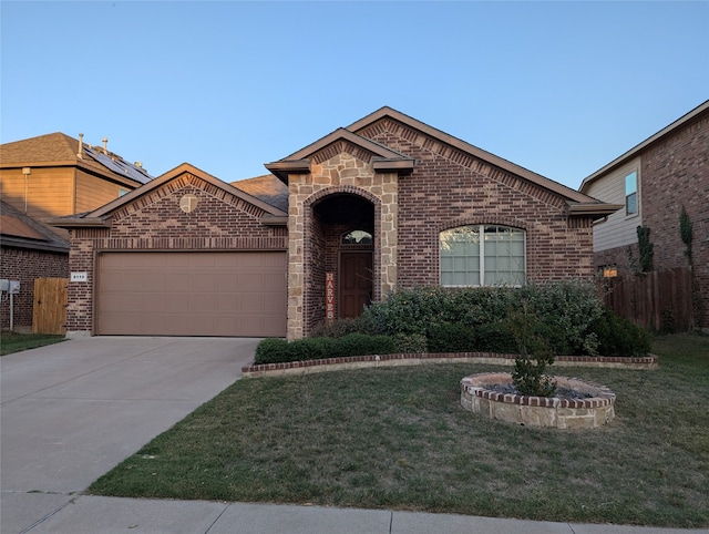 view of front of home with a front lawn and a garage