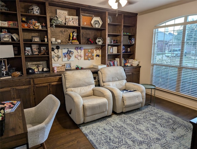 sitting room with dark wood-type flooring and crown molding