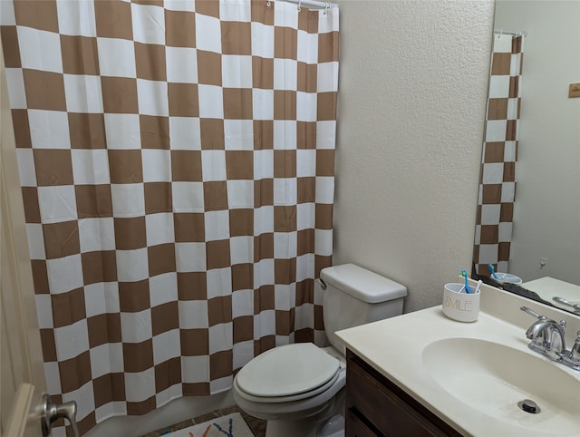 bathroom with vanity, toilet, and a shower with shower curtain