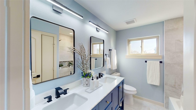 bathroom featuring a bathing tub, tile patterned flooring, vanity, and toilet