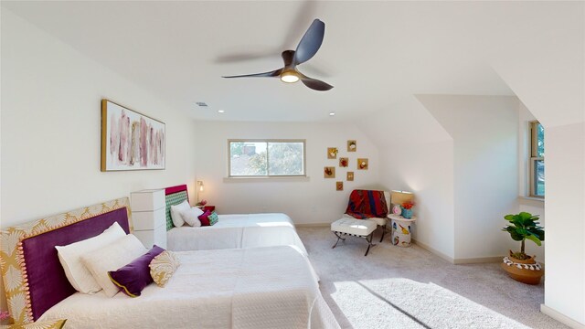 bedroom featuring light carpet, lofted ceiling, and ceiling fan