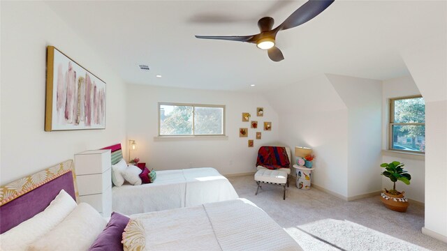 bedroom featuring ceiling fan, lofted ceiling, light carpet, and multiple windows