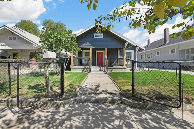 bungalow with a porch and a front lawn