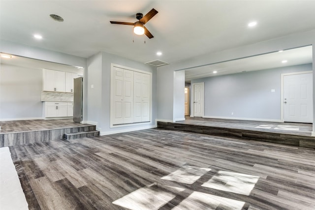 kitchen featuring dark wood-type flooring, white cabinets, sink, tasteful backsplash, and stainless steel appliances