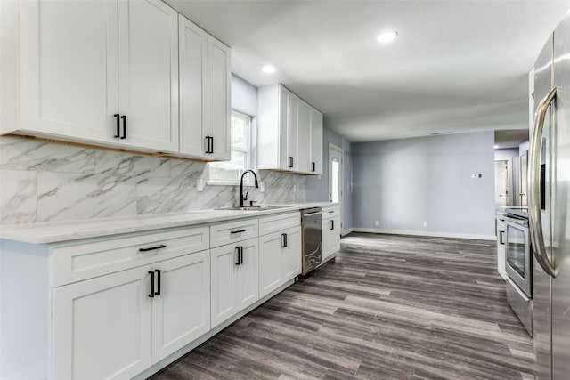 kitchen with white cabinetry, sink, appliances with stainless steel finishes, and dark wood-type flooring