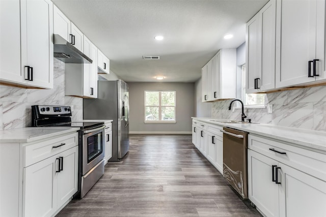 unfurnished bedroom featuring dark hardwood / wood-style flooring, ensuite bath, and ceiling fan