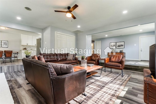 spare room featuring ceiling fan, plenty of natural light, and dark wood-type flooring