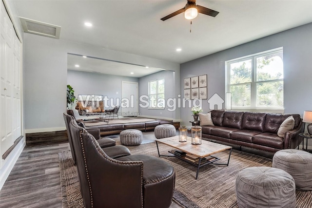 unfurnished living room featuring a fireplace, hardwood / wood-style flooring, and ceiling fan