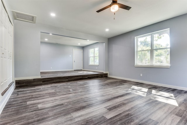 unfurnished living room featuring ceiling fan and wood-type flooring