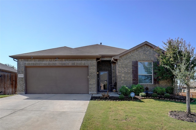 view of front of house with a front lawn and a garage