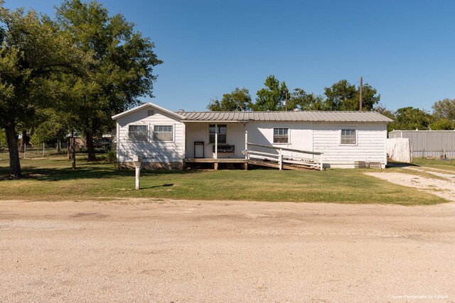 view of side of home featuring a yard and a wooden deck