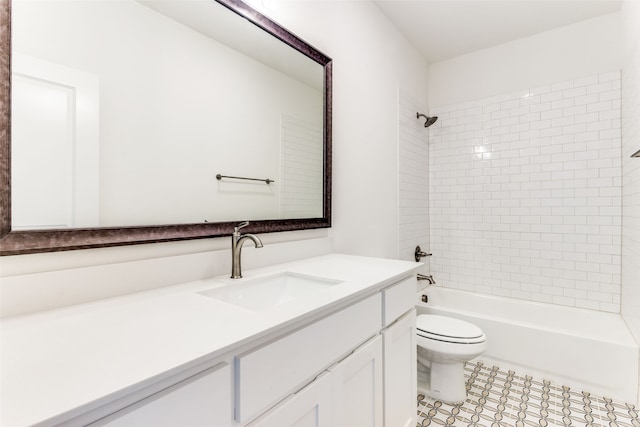 full bathroom with vanity, tiled shower / bath combo, and toilet